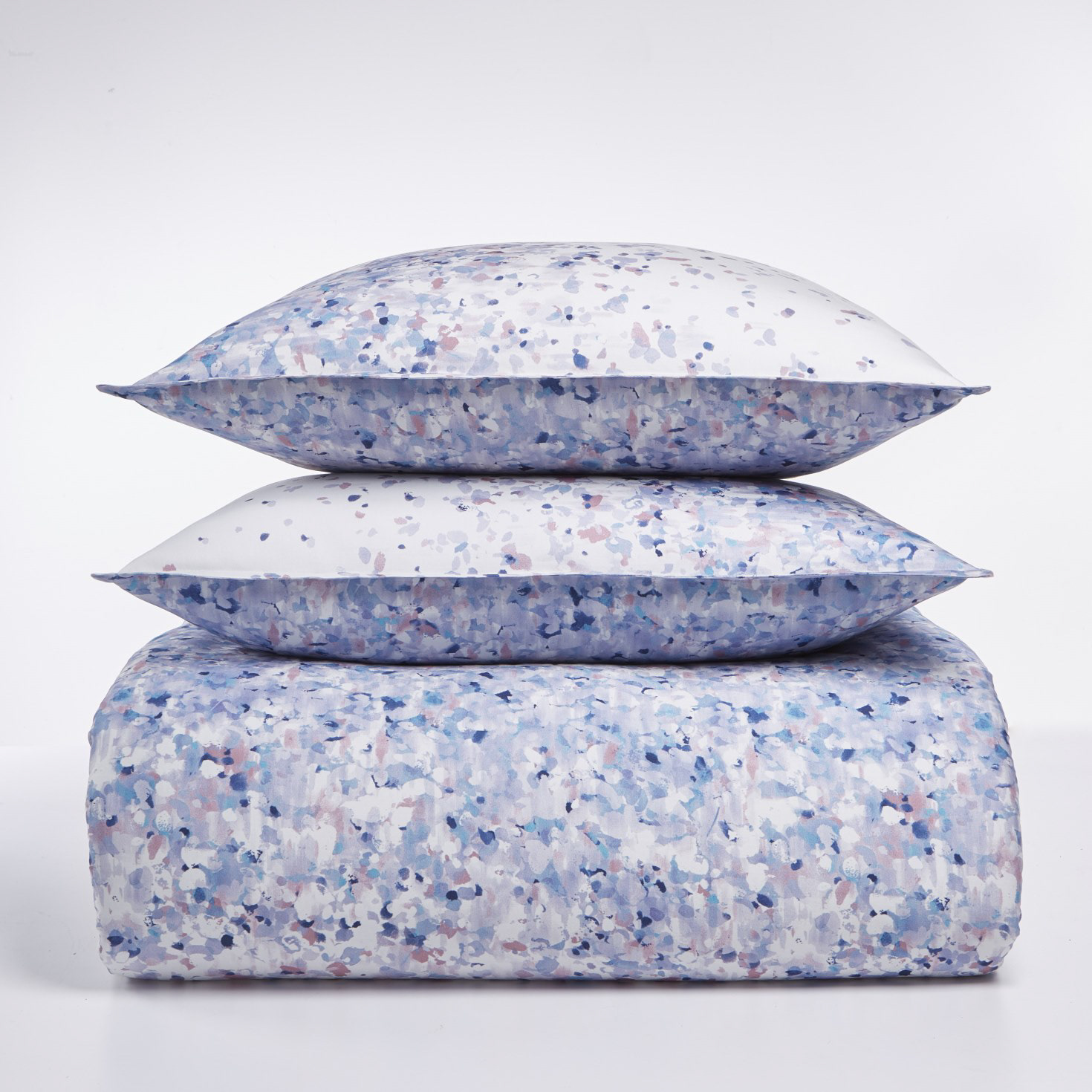 A stacked set of bedding with a blue abstract pattern