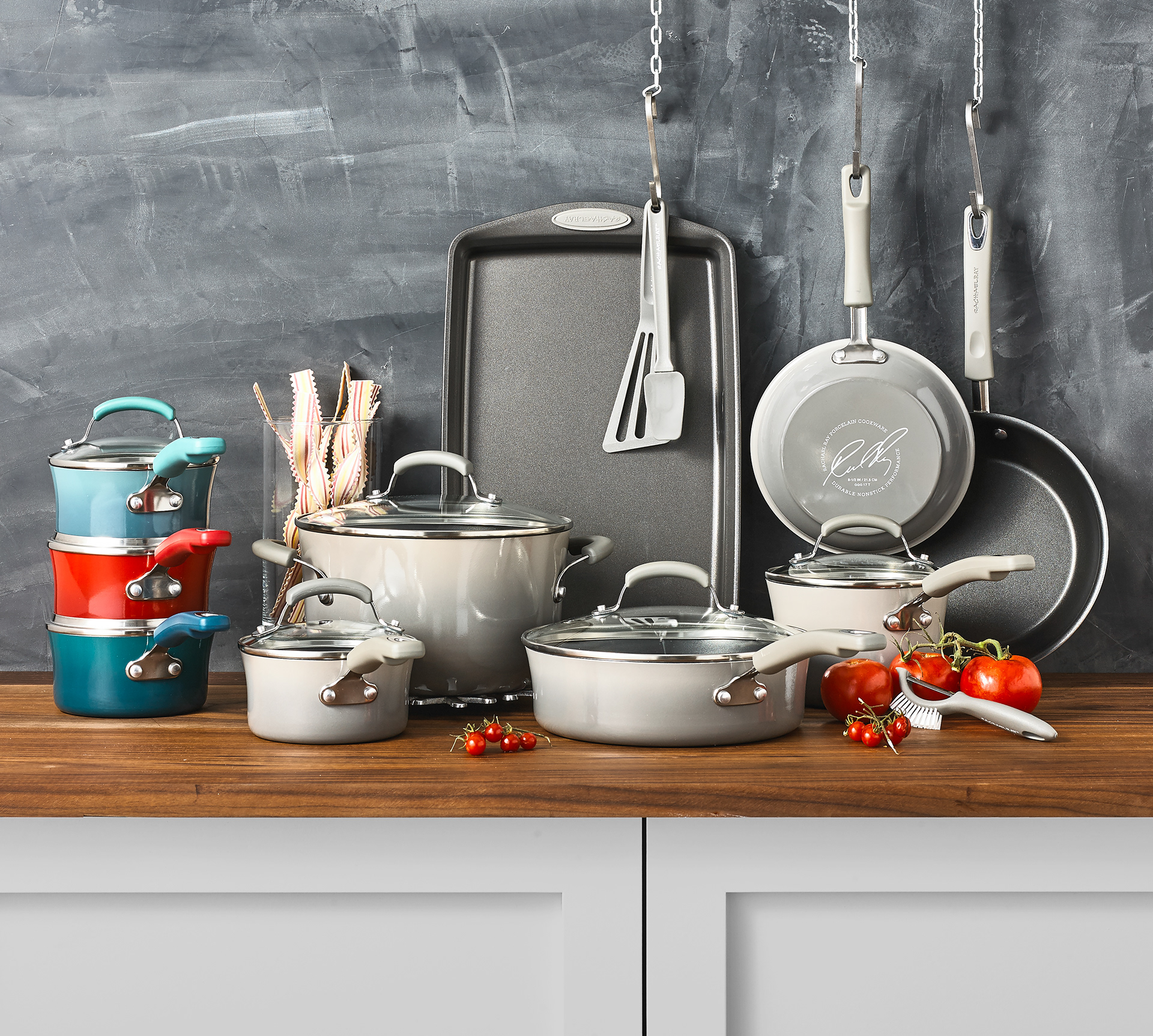 Stylishly arranged set of colorful cookware on a wooden counter