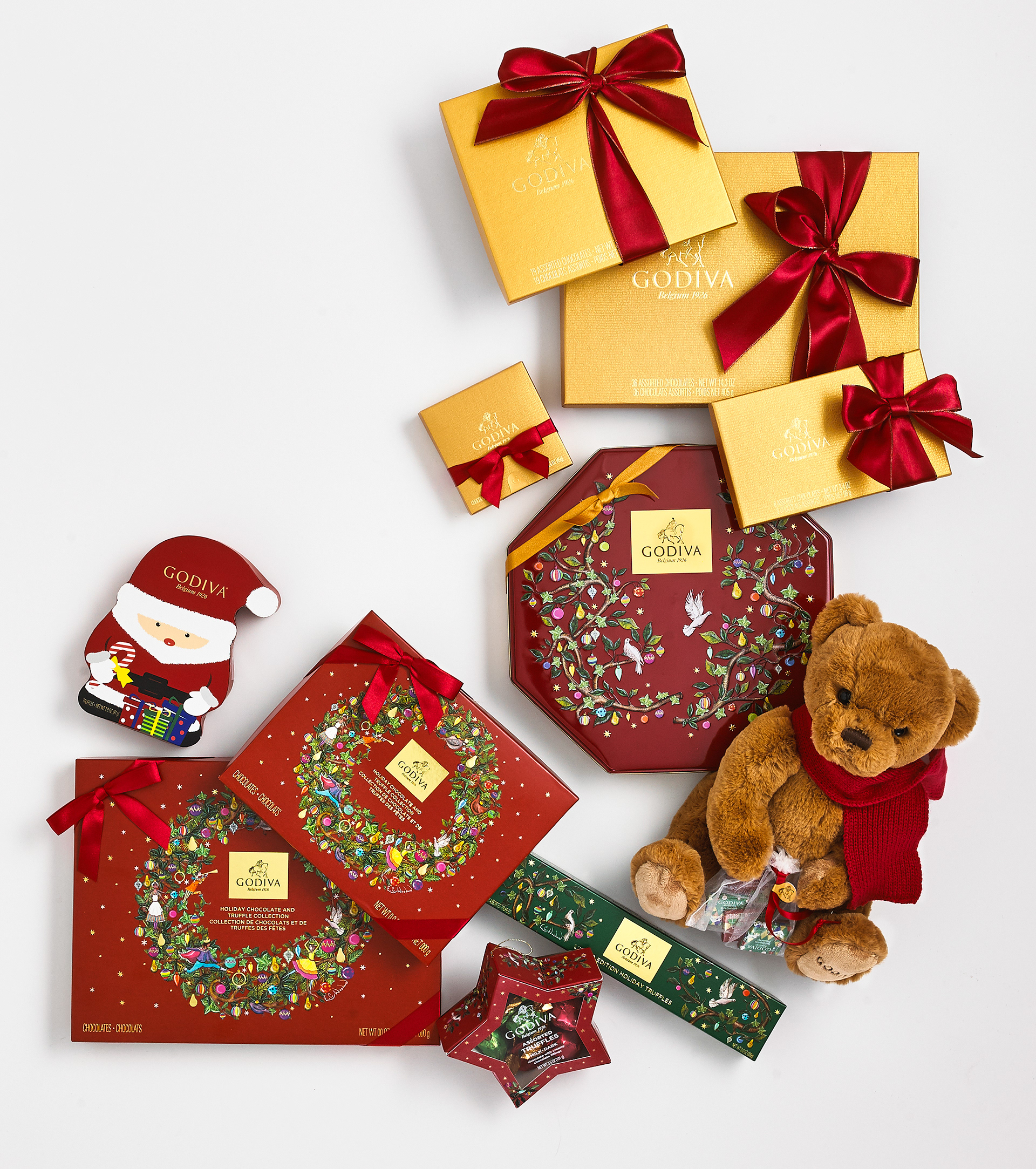 Festive flat-lay of Godiva holiday chocolate boxes and a teddy bear