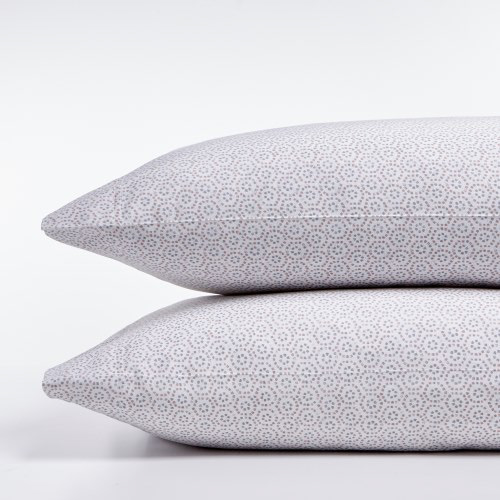 Close-up of two stacked pillows with a geometric pattern