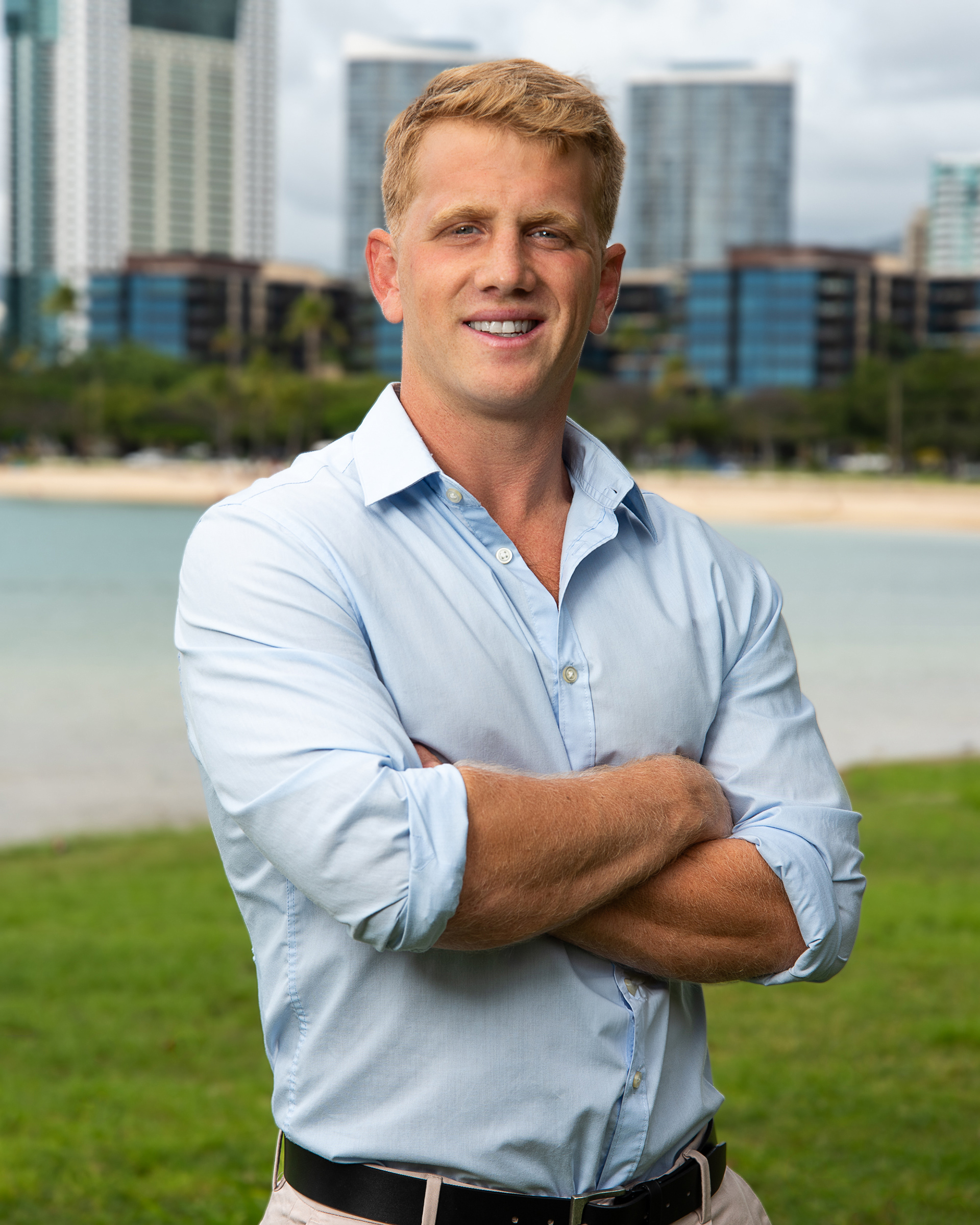 Professional outdoor portrait of a man with arms crossed