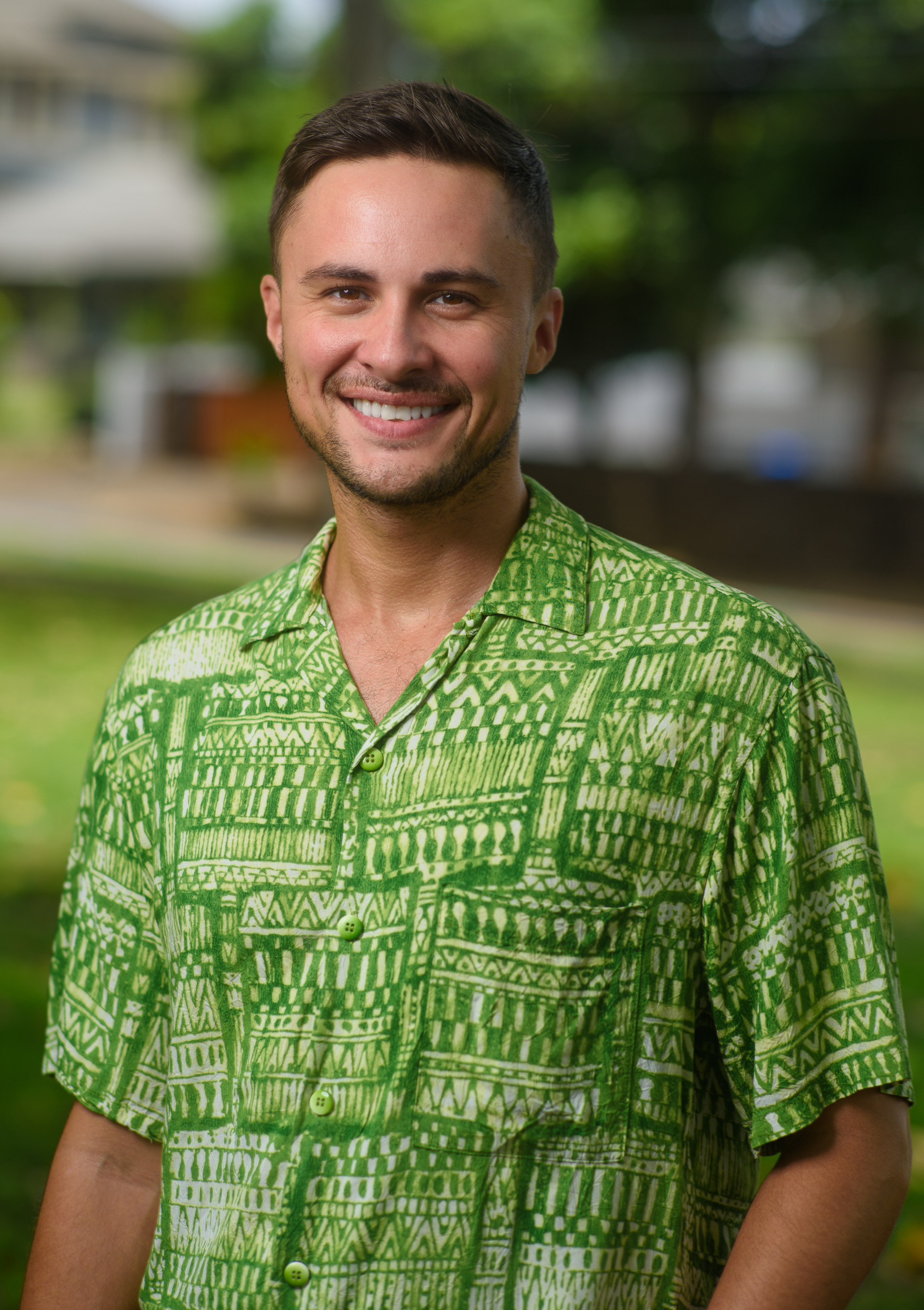 Outdoor portrait of a smiling man in a green aloha shirt