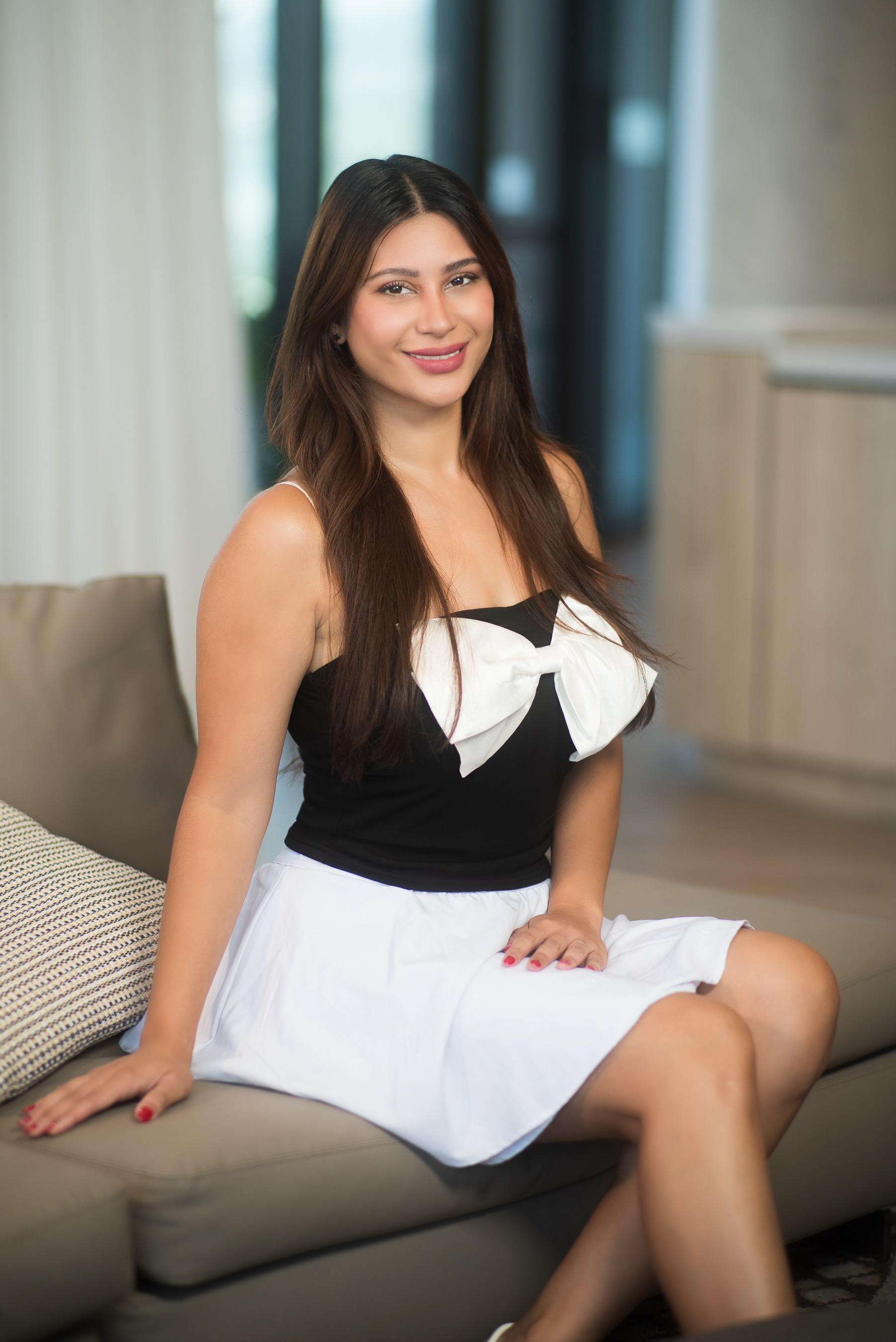 Elegant indoor portrait of a woman sitting on a couch