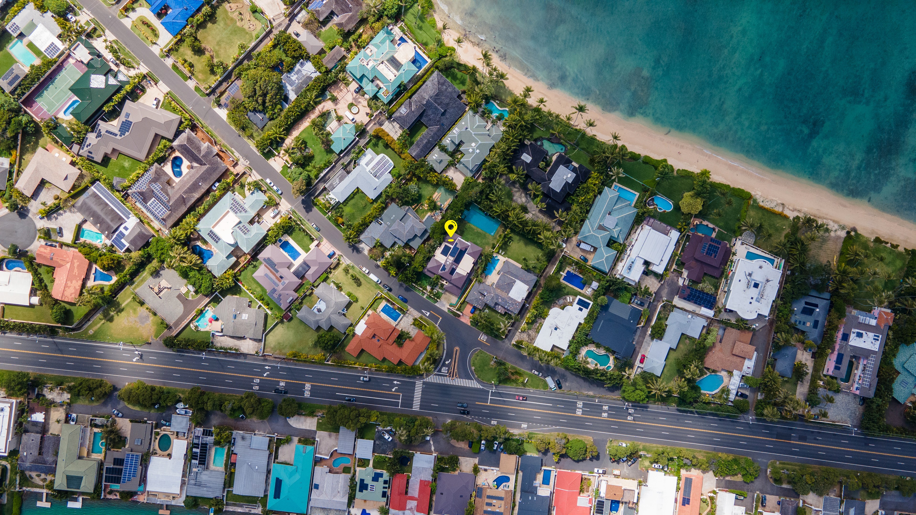 Top-down aerial view of luxury coastal homes by the beach