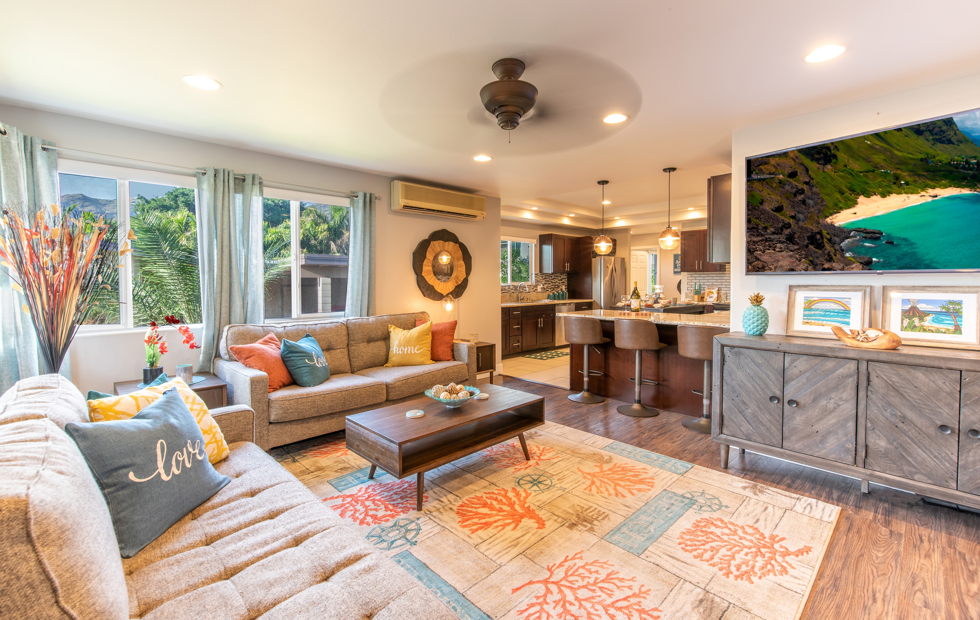 Living room with a cozy coastal theme and open-plan kitchen