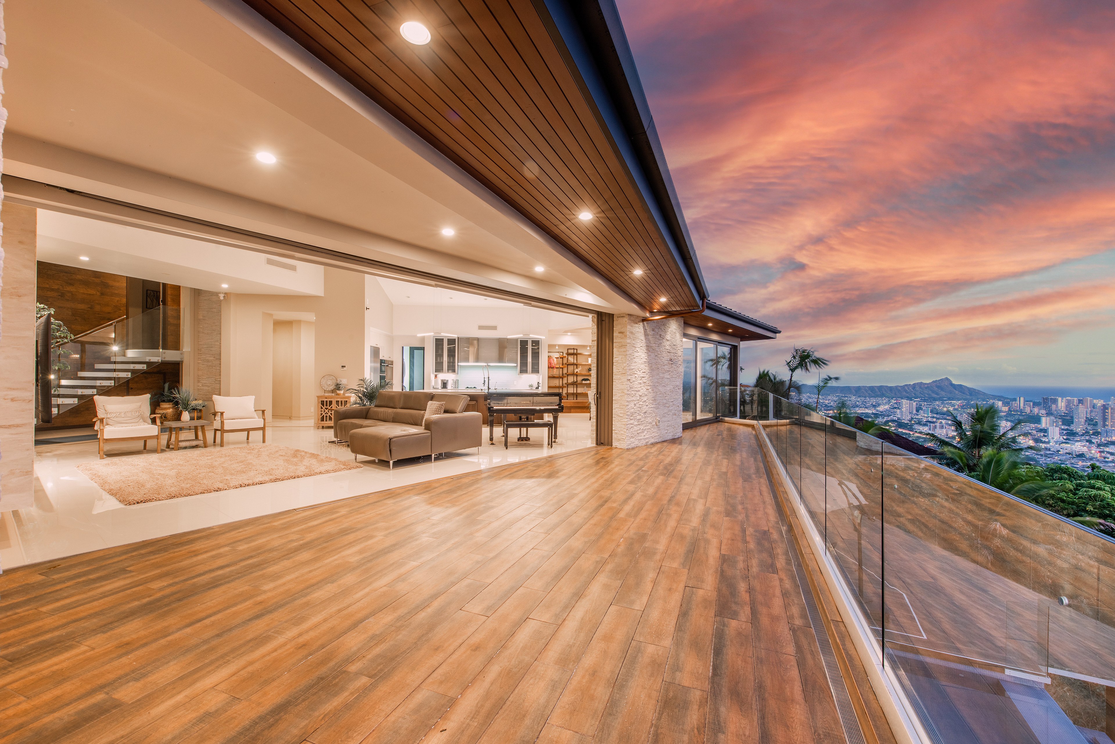 Expansive luxury lanai with a stunning sunset view over the city